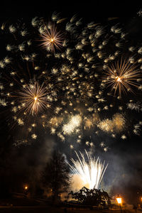 Low angle view of firework display at night