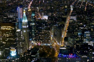 Aerial view of city lit up at night