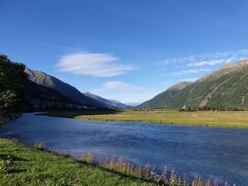 Scenic view of lake and mountains against sky