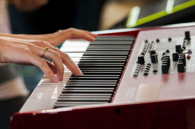 Close-up of hand playing piano