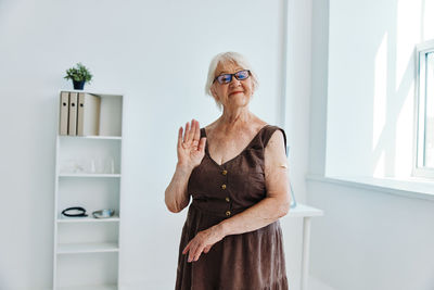 Full length of woman standing at home