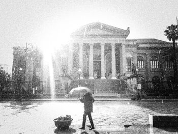 Full length of man standing on rainy day