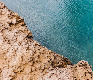 High angle view of rock by sea