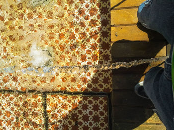 Low section of people standing on tiled floor