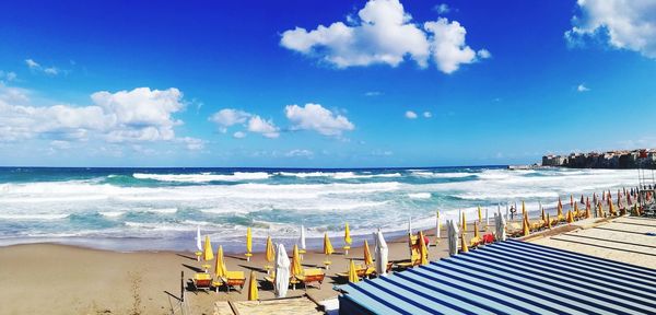 Scenic view of beach against blue sky