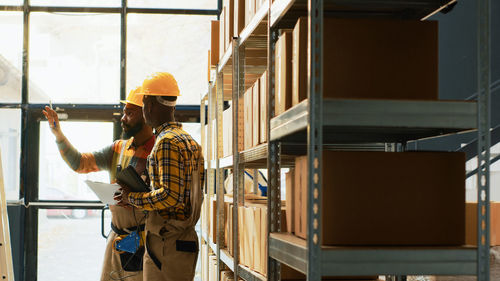 Rear view of man standing in factory