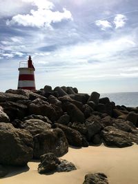 Rocks and lighthouse at beach
