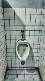 Close-up of electric lamp hanging in bathroom