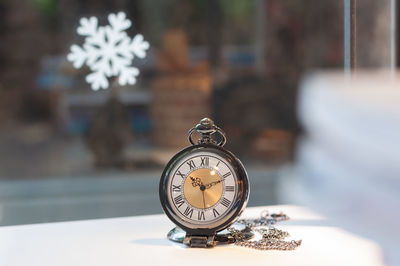 Close-up of clock on table