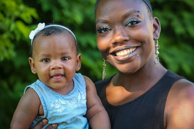 Portrait of smiling woman with daughter