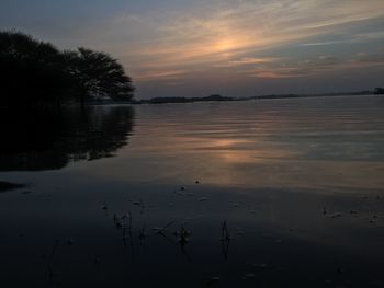 Scenic view of lake against sky during sunset