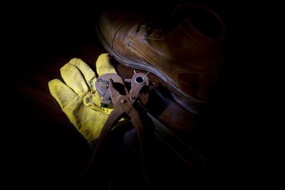 Close-up of yellow shoes over black background