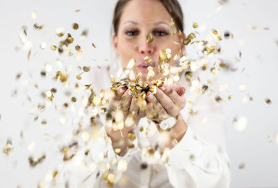 Close-up of young woman against white background