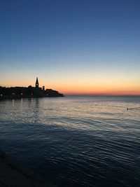 Scenic view of sea against clear sky during sunset