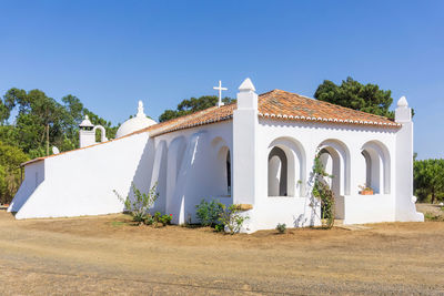 White walls and red tile roof of an old catholic church in portugal