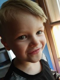 Close-up portrait of smiling boy at home