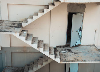 Abandoned building and apartment in urban city shows grunge staircase and door for fire escape 