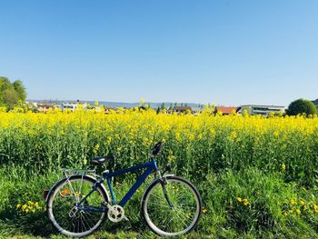 Bicycles on field against clear sky