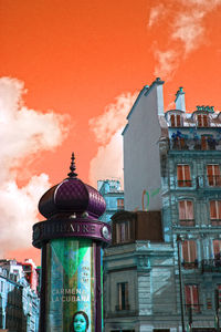 Low angle view of buildings against cloudy sky