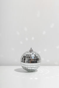 Close-up of crystal ball against white background