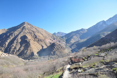 Scenic view of mountains against clear blue sky