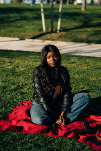 Young woman sitting on field