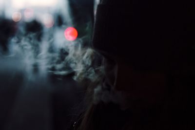 Close-up of person emitting smoke