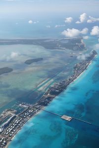 Aerial view of sea and mountains against sky