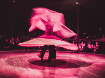 People in illuminated stage