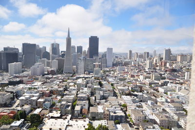 View of cityscape against cloudy sky