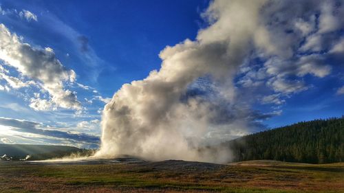 Smoke on field against sky