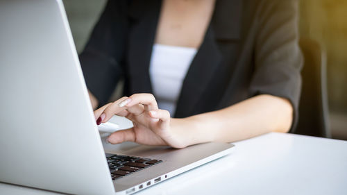 Midsection of woman using mobile phone