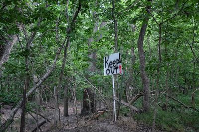Keep out signboard in forest