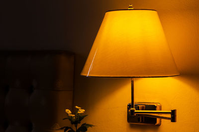 Close-up of illuminated lamp on table at home