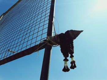 Low angle view of hanging against clear blue sky