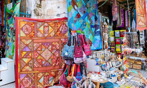 Multi colored umbrellas hanging for sale at market stall