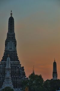 Low angle view of tower against sky at sunset