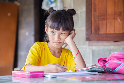 Portrait of a girl sitting on table