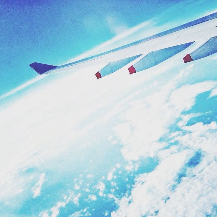 blue, airplane, transportation, sky, air vehicle, low angle view, mode of transport, aircraft wing, flying, cloud - sky, white color, cloud, day, journey, part of, travel, outdoors, cropped, nature, no people