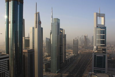 Modern buildings in city against clear sky