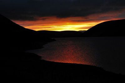 Scenic view of silhouette mountain against sky during sunset