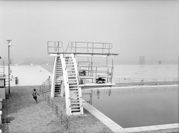 Man in swimming pool against clear sky