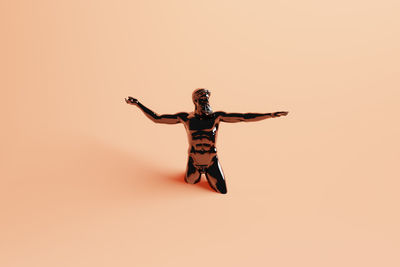 High angle view of human figurine against pink background