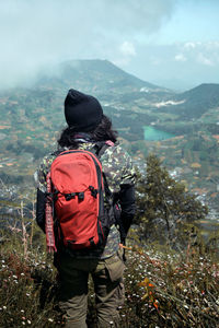 Rear view of man looking at mountains