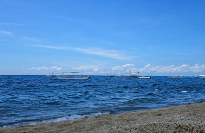 Scenic view of sea against blue sky