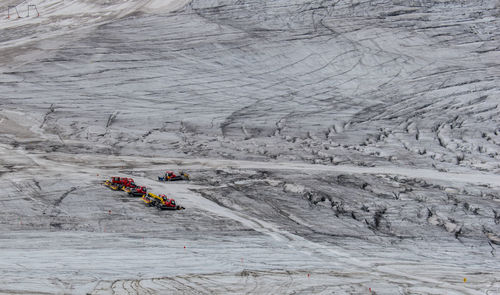 High angle view of snow groomers on landscape at mayrhofen