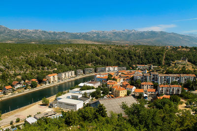 High angle view of trees and mountains against clear sky