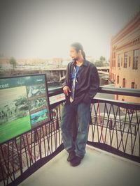 Young man using mobile phone standing outdoors