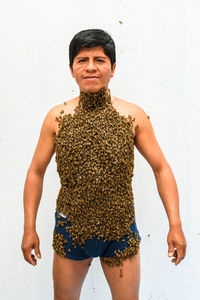 Man covered by many bees