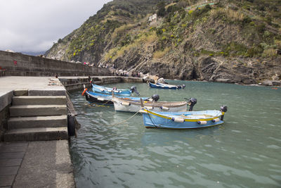 Boats moored on sea against sky